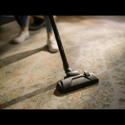 rug is being cleaned with vacuum cleaner